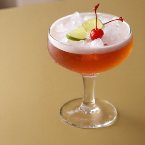 An image of the Death Bed cocktail submitted by Toby that contains Gold Rum, Agricole Rhum, Cherry Brandy, Lime, Pineapple Juice, Lime and Cocktail Cherry