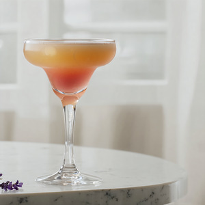 An image of the Eau de Lavende cocktail submitted by Carsten that contains Nordés Galician Gin, Lemon, Very Rich Simple Syrup (3:1), Egg, Lemon and Cucumis Lavender Lemonade