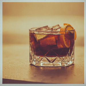 An image of the Four Rum Old Fashioned cocktail submitted by Toby that contains Agricole Rhum, Arrack, Gold Rum, Cinnamon Syrup, Bob's Bitters Abbott's Bitter, Angostura Bitters, Lime and Orange