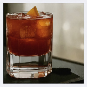 An image of the French Derby cocktail submitted by Toby that contains London Dry Gin, Pear Brandy, Whiskey Barrel Aged Bitters and Mint