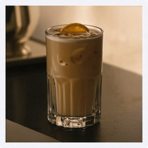 An image of the Milk Punch cocktail submitted by Toby that contains Brandy, Dark Rum, Simple Syrup, Vanilla Extract and Milk