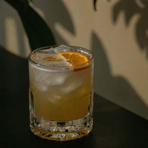 An image of the White Gin Fizz cocktail submitted by Toby that contains London Dry Gin, Lemon, Simple Syrup, Lemon Sorbet, Soda Water and Orange