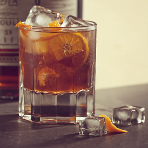 An image of the Xocula cocktail submitted by Toby that contains Amaro Montenegro, Amontillado Sherry, Mezcal, Xocolatl Mole Bitters and Orange