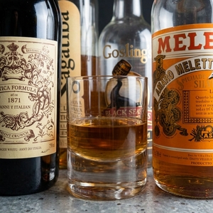 An image of the Arrack Strap cocktail submitted by Toby that contains Dark Rum, Arrack, Sweet Vermouth, Turin Bitters, Demerara Syrup, Xocolatl Mole Bitters, Orange Bitters and Orange