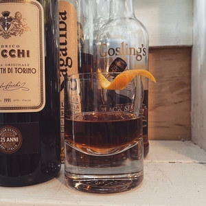 An image of the Arrack Strap cocktail submitted by Toby that contains Dark Rum, Arrack, Sweet Vermouth, Turin Bitters, Demerara Syrup, Xocolatl Mole Bitters, Orange Bitters and Orange