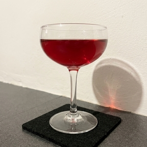 An image of the Boomerang Cocktail cocktail submitted by Toby that contains Canadian Whiskey, Dry Vermouth, Swedish Flaggpunsch, Lemon and Angostura Bitters