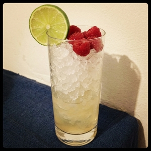 An image of the Bramble cocktail submitted by Toby that contains London Dry Gin, Lime, Simple Syrup, Crème de Mûre, Lime and Raspberries