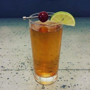 An image of the Carbonated Piston Slinger cocktail submitted by Toby that contains Dark Rum, Sloe Gin, Lime, Soda Water, Cocktail Cherry and Lime