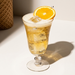 An image of the Chinese Fizz cocktail submitted by Toby that contains Gold Rum, Cointreau, Maraschino Liqueur, Lemon, Simple Syrup, Grenadine, Egg, Angostura Bitters and Orange