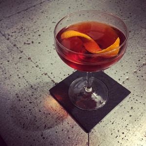 An image of the Cigar Lover's Martini cocktail submitted by Toby that contains Cognac, Tawny Port and Orange