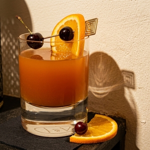 An image of the Claremont cocktail submitted by Toby that contains Bourbon, Curaçao Triple Sec, Angostura Bitters, Orange, Cherries and Soda Water