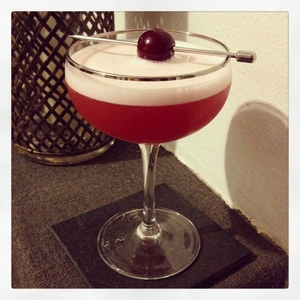 An image of the Cuban Shake cocktail submitted by Toby that contains White Rum, Apple Brandy, London Dry Gin, Lemon Barley Water and Cocktail Cherry