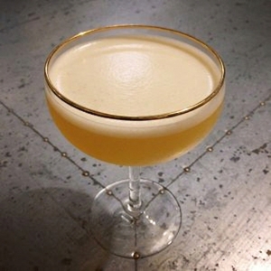 An image of the Elephants Kick cocktail submitted by Toby that contains London Dry Gin, Gold Rum, Curaçao Triple Sec, Orange and Grand Marnier