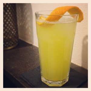 An image of the Felonious Monk cocktail submitted by Toby that contains London Dry Gin, Lemon, Yellow Chartreuse, Benedictine DOM, Angostura Bitters, Egg, Abbey Beer and Orange