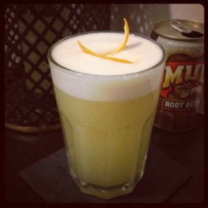 An image of the Ginger Baker Fizz cocktail submitted by Toby that contains London Dry Gin, Lemon, Crème de Cacao Blanc, Ginger Liqueur, Cream, Egg, Ginger Beer and Orange