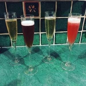 An image of the Ginger Pomegranite Champagne Cocktail cocktail submitted by Toby that contains Sparkling Wine, Pomegranite Juice, Caster Sugar, Fresh Ginger, Orange and Curaçao Triple Sec