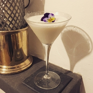 An image of the Island Rose cocktail submitted by Toby that contains Blanco Tequila, Kahlua, Crème de Framboise, Cream and Edible Flower