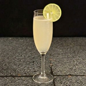 An image of the La Cola Nostra cocktail submitted by Toby that contains Gold Rum, Averna, Lime, Simple Syrup, Allspice Dram, Champagne and Lime