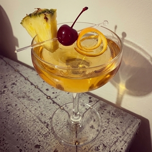 An image of the Mai Tai cocktail submitted by Toby that contains White Rum, Dark Rum, Curaçao Triple Sec, Lime, Orgeat Syrup, Grenadine, Cocktail Cherry, Pineapple and Orange