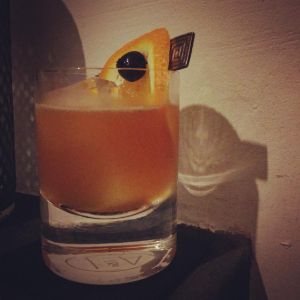 An image of the Man O' War cocktail submitted by n0tquitethere that contains Bourbon, Curaçao Triple Sec, Sweet Vermouth, Lemon, Orange and Cocktail Cherry
