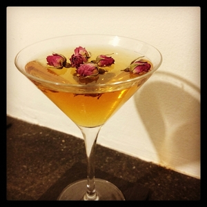 An image of the Mata Hari cocktail submitted by Toby that contains Cognac, Chai Infused Sweet Vermouth, Lemon, Pomegranite Juice, Simple Syrup and Dried Rose Buds