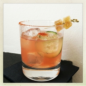An image of the Mezcal Mule cocktail submitted by Toby that contains Mezcal, Ginger Beer, Lime, Passion Fruit Purée, Agave Syrup, Cucumber, Crystallised Ginger and Chilli Powder