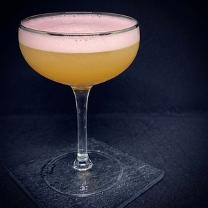 An image of the Million Dollar cocktail submitted by Toby that contains London Dry Gin, Sweet Vermouth, Pineapple Juice, Grenadine and Egg