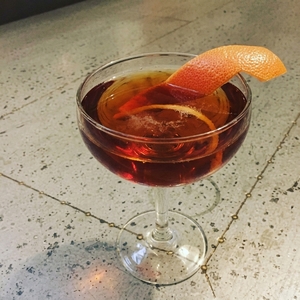 An image of the Pleasant Evening cocktail submitted by Toby that contains Grapefruit, Crème de Cassis, Peach Bitters, Champagne and Grapefruit