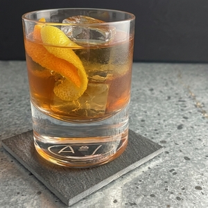An image of the Rack & Rye cocktail submitted by Toby that contains Rye Whiskey, Arrack, Demerara Syrup, Angostura Bitters, Orange Bitters, Orange and Lemon