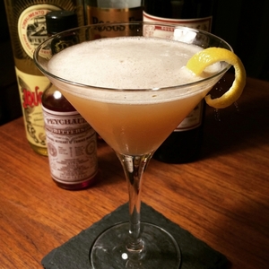 An image of the Rebennack cocktail submitted by Toby that contains Bourbon, Ramazzotti, Strega, Orange Bitters, Peychauds Bitters and Lemon