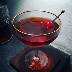 An image of the Red Ant cocktail submitted by Toby that contains Rye Whiskey, Kirschwasser, Cherry Brandy, Mezcal, Xocolatl Mole Bitters and Cocktail Cherry