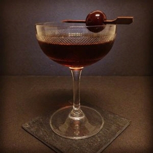 An image of the San Francisco Cocktail cocktail submitted by Toby that contains Sloe Gin, Sweet Vermouth, Dry Vermouth, Aromatic Bitters, Orange Bitters and Cocktail Cherry