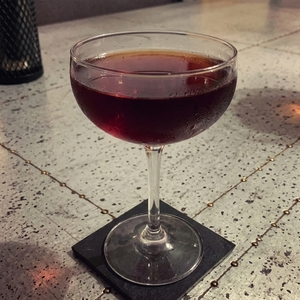 An image of the Six Inch Gold Blade cocktail submitted by Toby that contains Smith & Cross, Punt e Mes, Nardini Amaro, Turin Bitters, Single Malt Scotch, Angostura Bitters, Xocolatl Mole Bitters and Orange