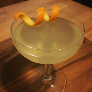 An image of the Smoked Scotch Sour cocktail submitted by Toby that contains Blended Scotch, Amaro Meletti, Lapsong Souchang Syrup, Egg, Orange, Lemon, Xocolatl Mole Bitters and Orange