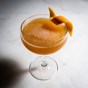 An image of the Smoky Grove cocktail submitted by Toby that contains Blended Scotch, Sweet Vermouth, Dry Vermouth, Angostura Bitters, Orange Bitters and Orange