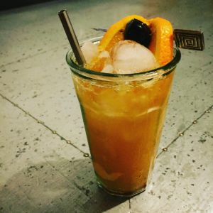 An image of the Spindrift Jr. cocktail submitted by n0tquitethere that contains Dark Rum, Lemon, Orange, Passion Fruit Syrup, Vanilla Syrup, Orange and Cocktail Cherry