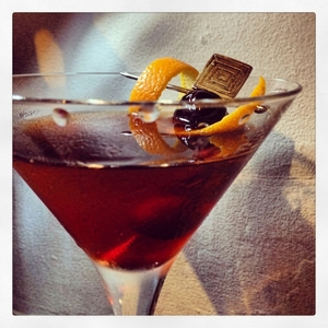 An image of the The Hobo cocktail submitted by Toby that contains Bourbon, Rye Whiskey, Quinquina, Cherry Brandy, Cocktail Cherry and Orange