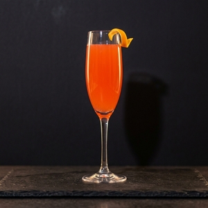 An image of the Waltz of the Flowers cocktail submitted by Toby that contains Agricole Rhum, St Germain, Aperol, Orange Flower Water, Peychauds Bitters, Cava and Orange