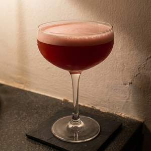 An image of the Wicked Wahine cocktail submitted by Toby that contains Spiced Rum, Falernum, Lemon, Lime, Passion Fruit Syrup, Grenadine and Peychauds Bitters
