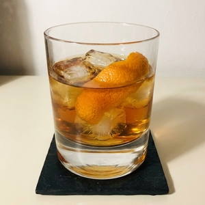 An image of the Xocula cocktail submitted by Toby that contains Amaro Montenegro, Amontillado Sherry, Mezcal, Xocolatl Mole Bitters and Orange